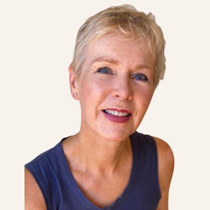 Dr Kate Harding smiles at the camera. she has short blonde hair and is wearing a blue tank top